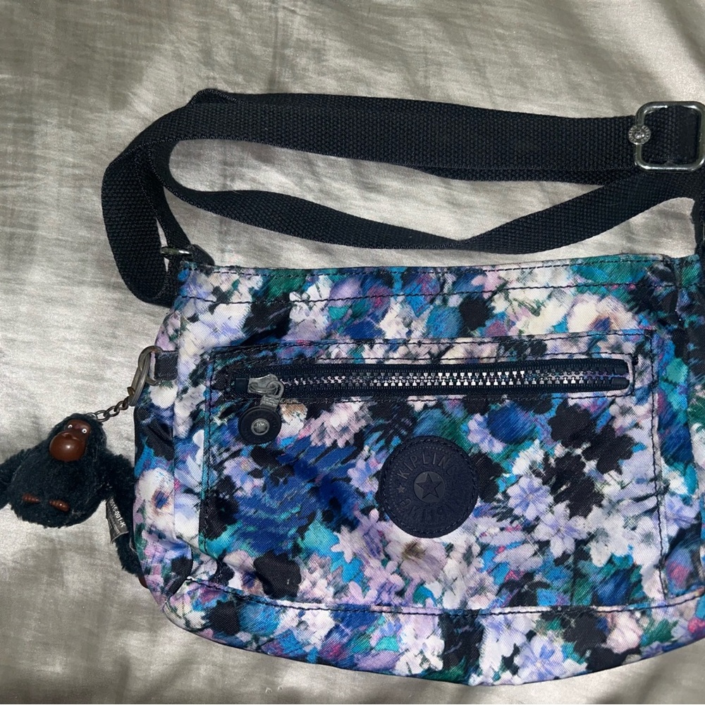 Kipling “Dixon” Printed Crossbody Bag in “Metallic Mauve”